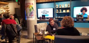 Two lesbian couples sit chatting with each other on a speed date